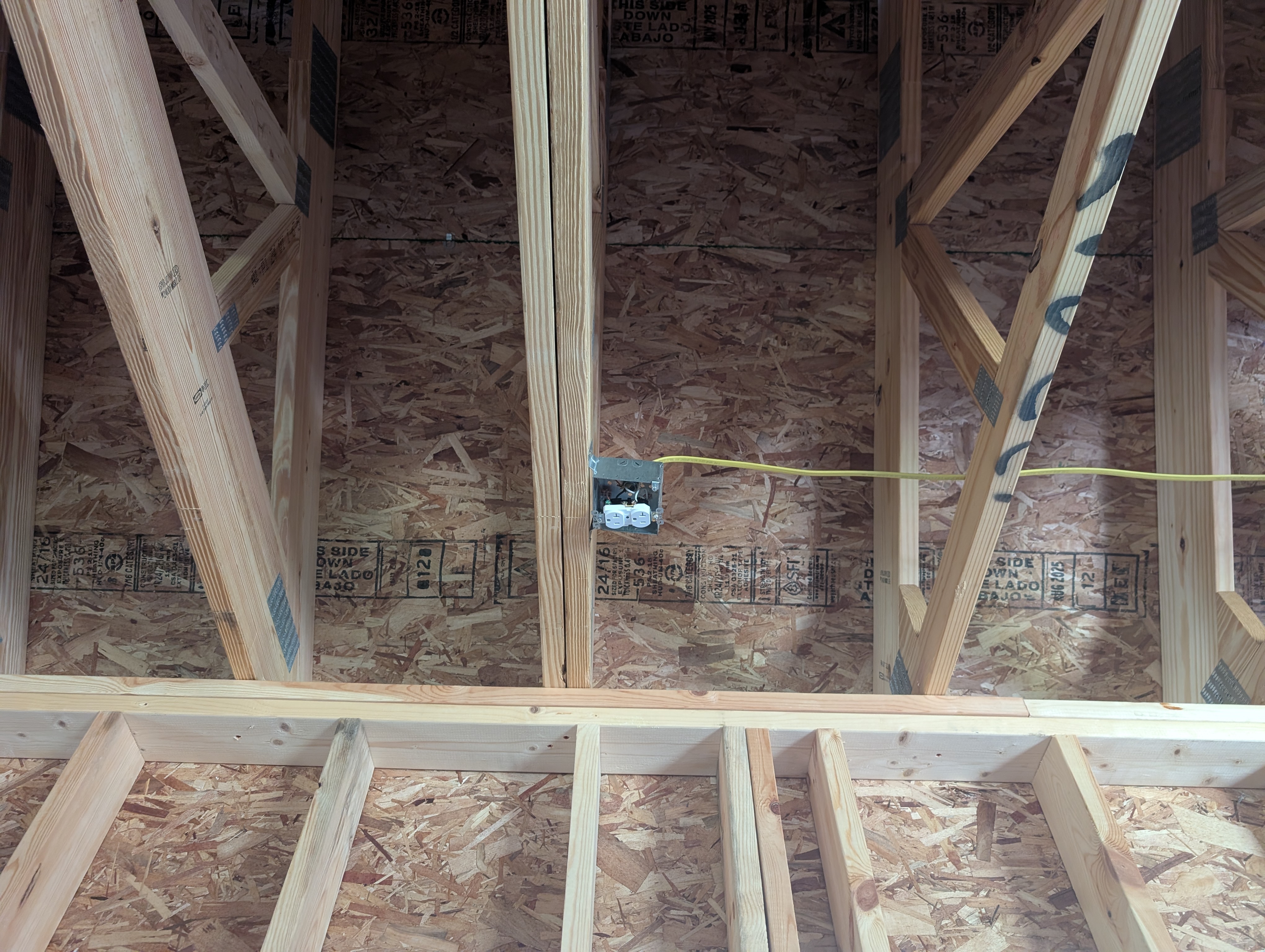 Bay 1 ceiling 4-inch square box with mud ring, fed by yellow NM-B running in from the right with no staple securing it near the box