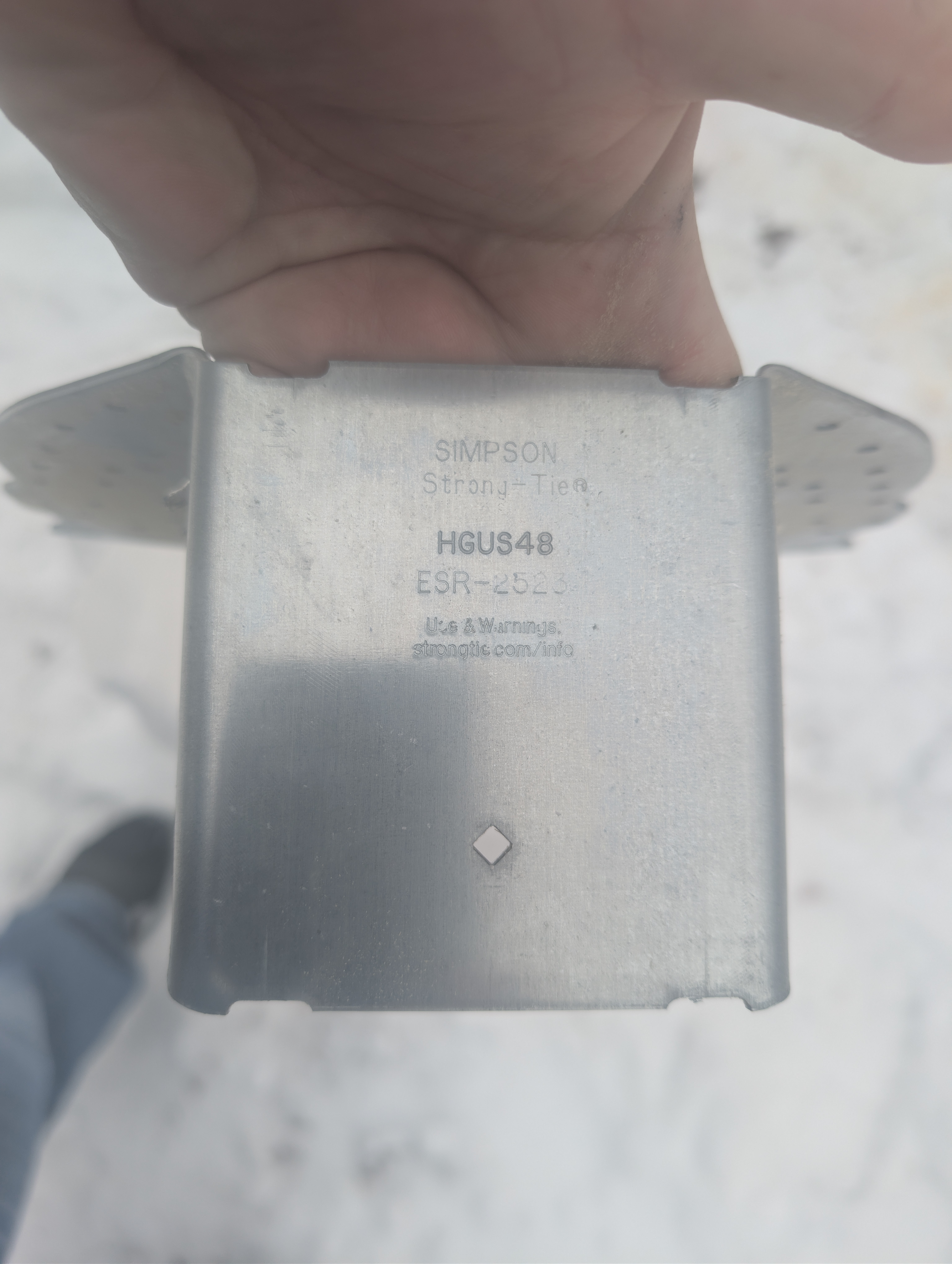 Close-up of Simpson HGUS48 hanger stamp