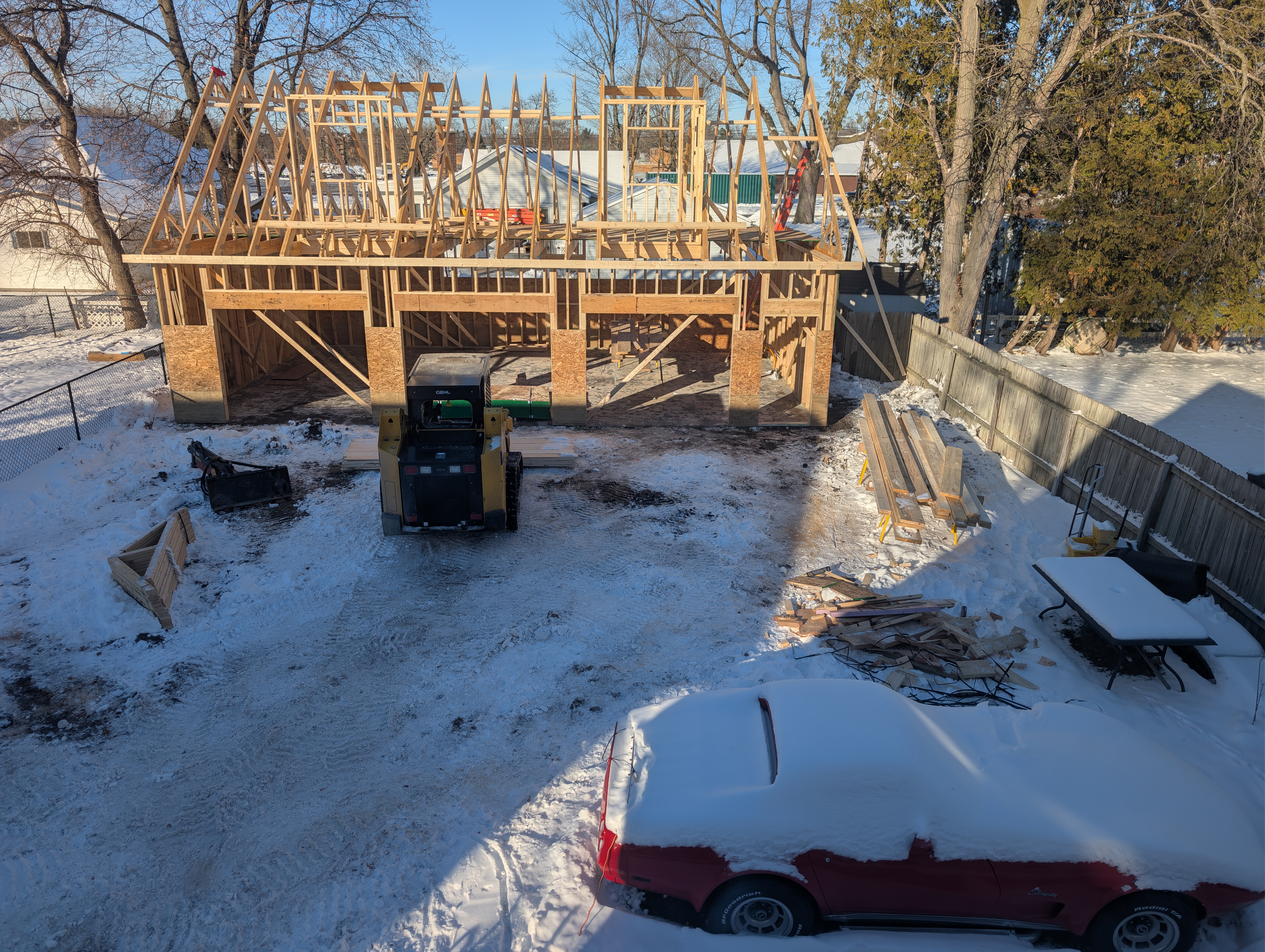 Elevated view of framed garage with loader parked in front