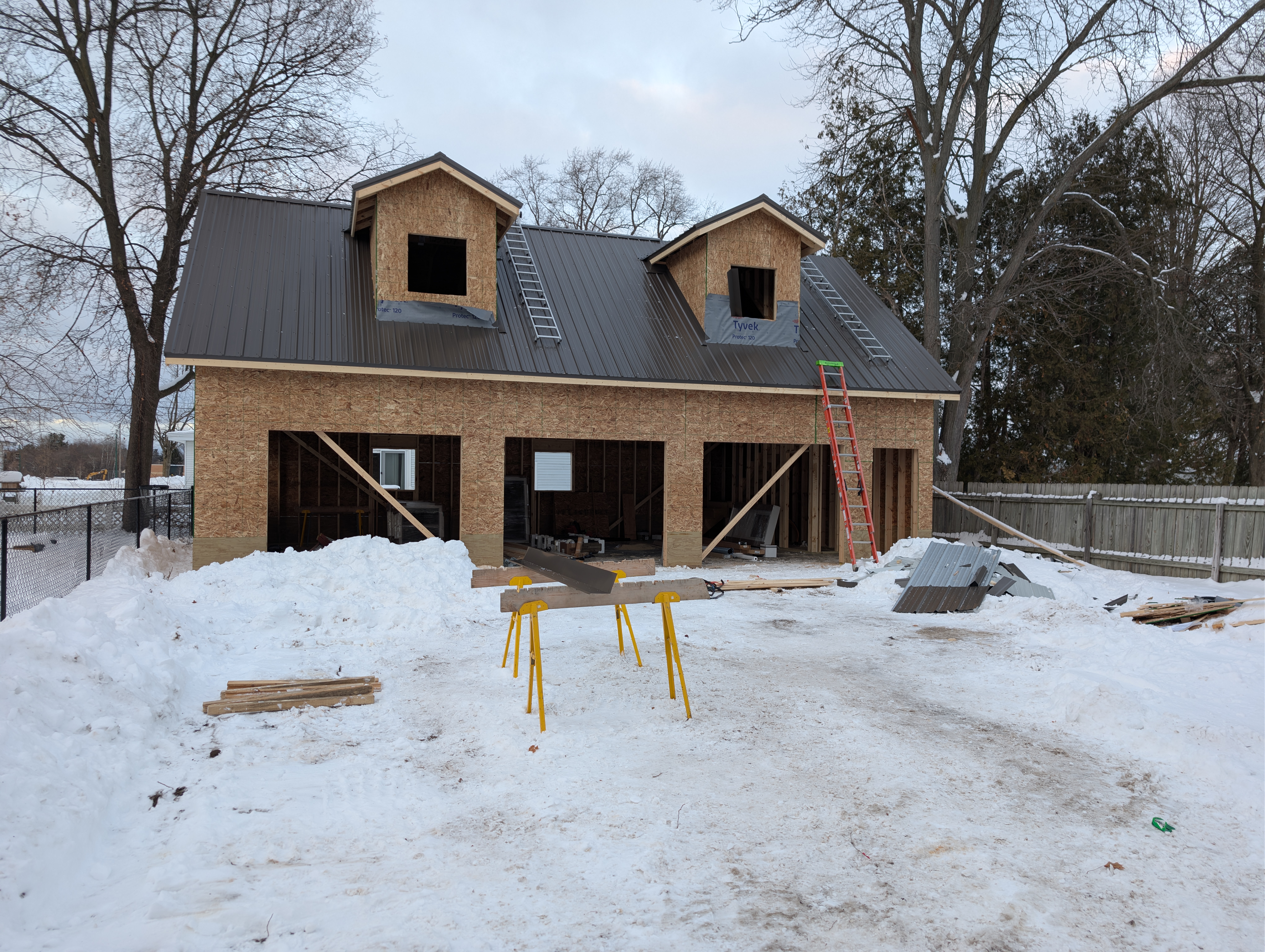 Front of garage with most standing-seam roof installed