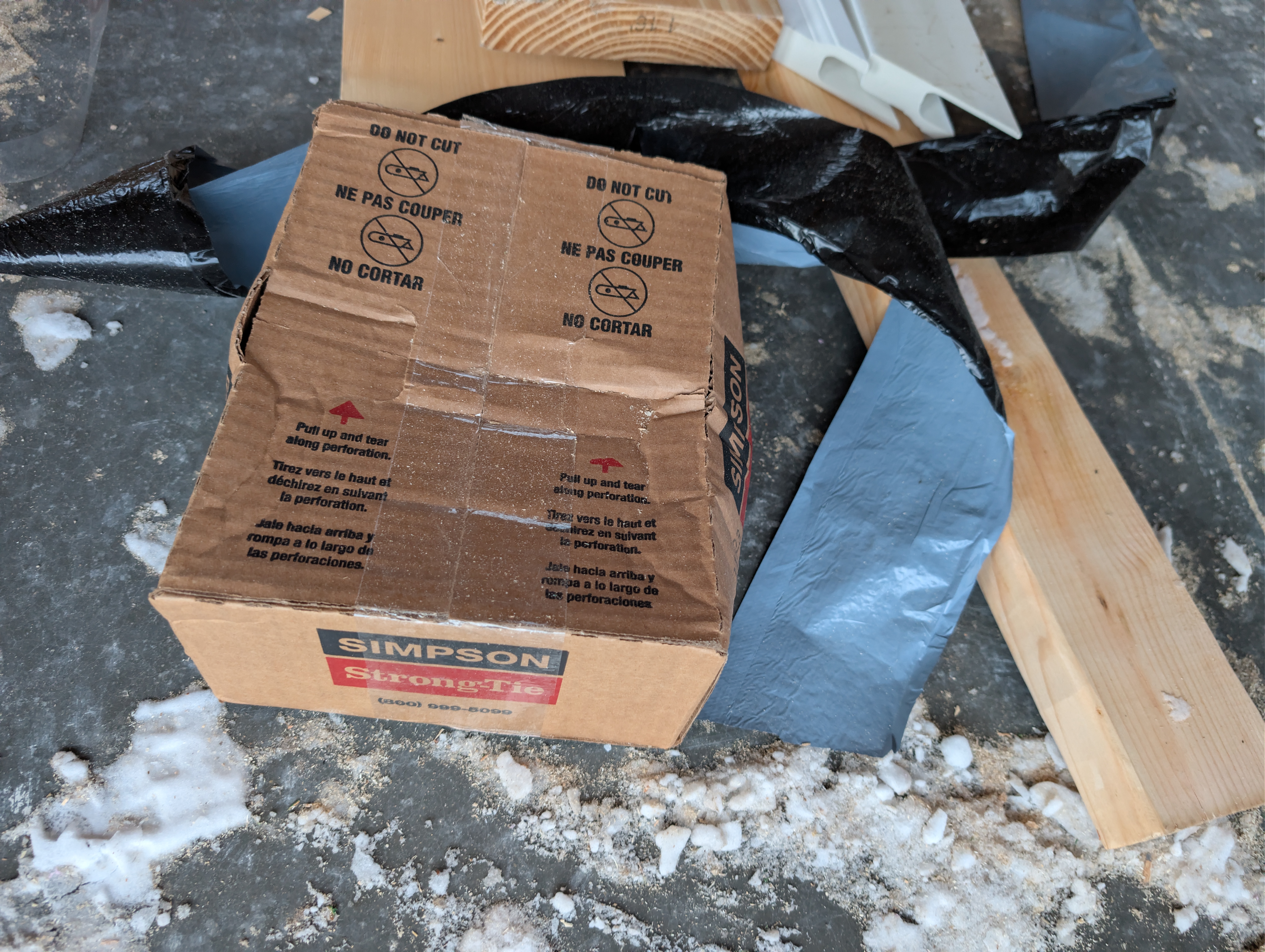 Simpson Strong-Tie box with flashing tape and lumber nearby