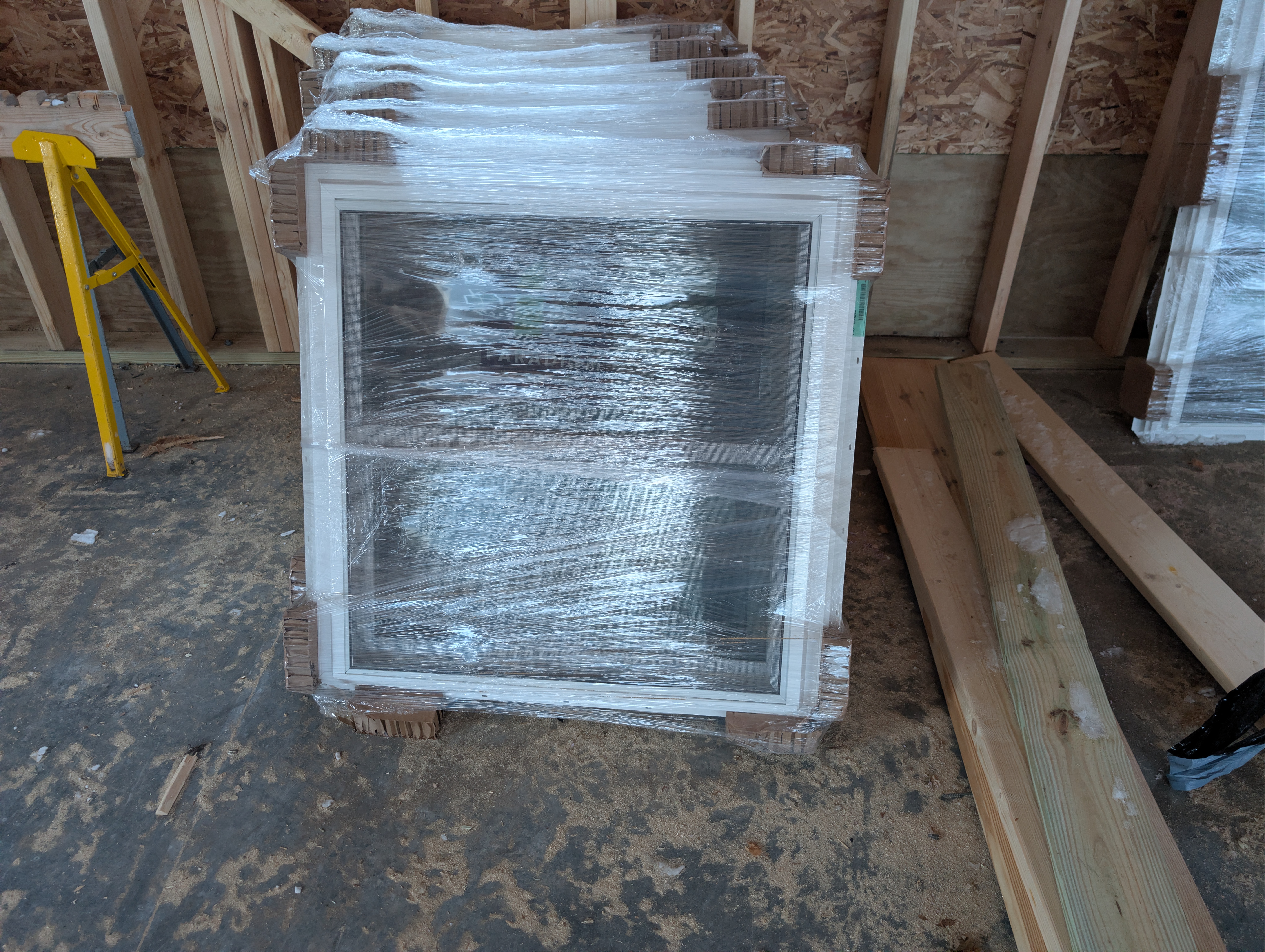 Stacked standard-size windows wrapped for delivery