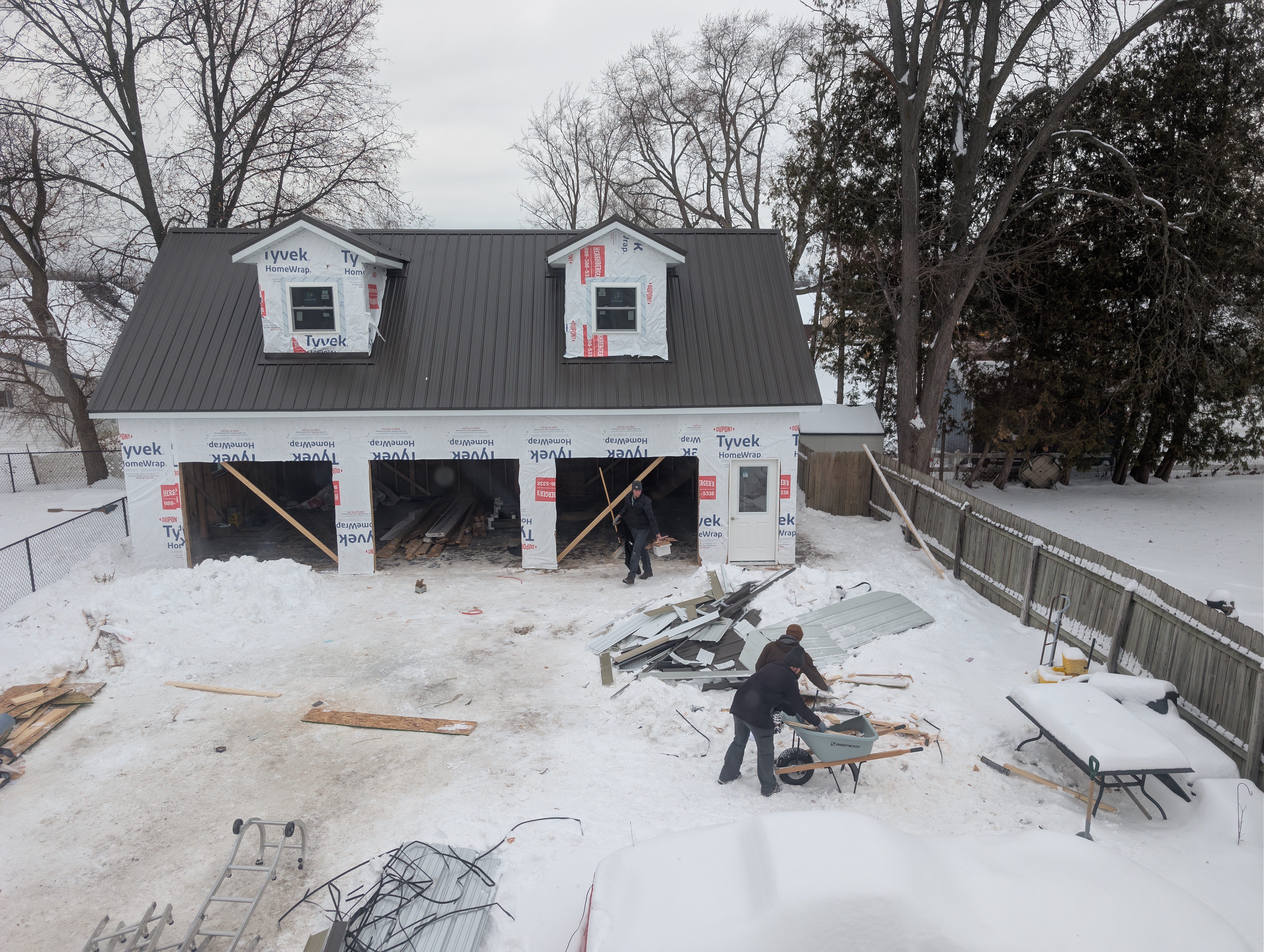 Aerial view of garage with finished metal roof, wrap, and installed windows