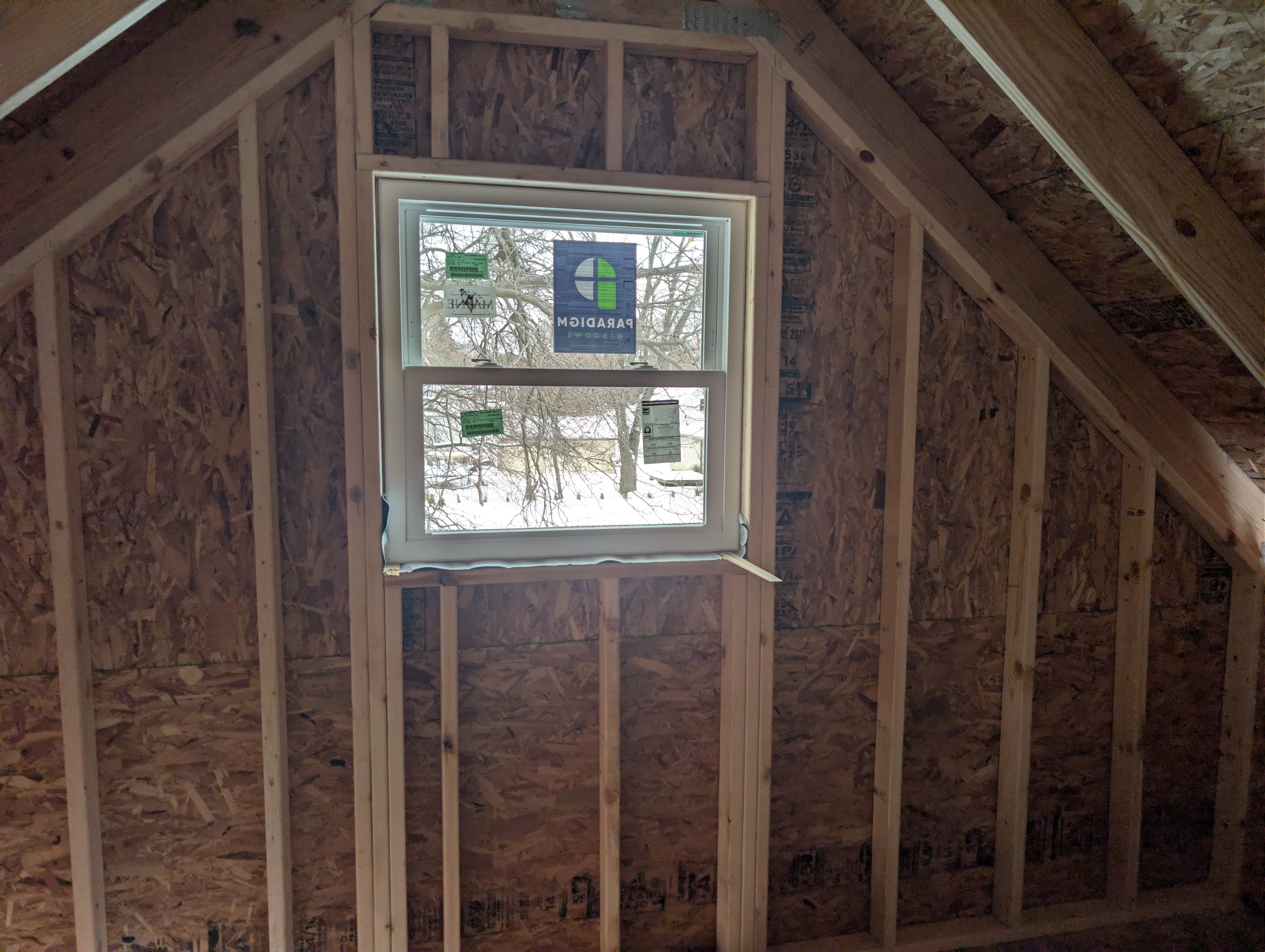 Close-up of loft gable window with stickers still applied