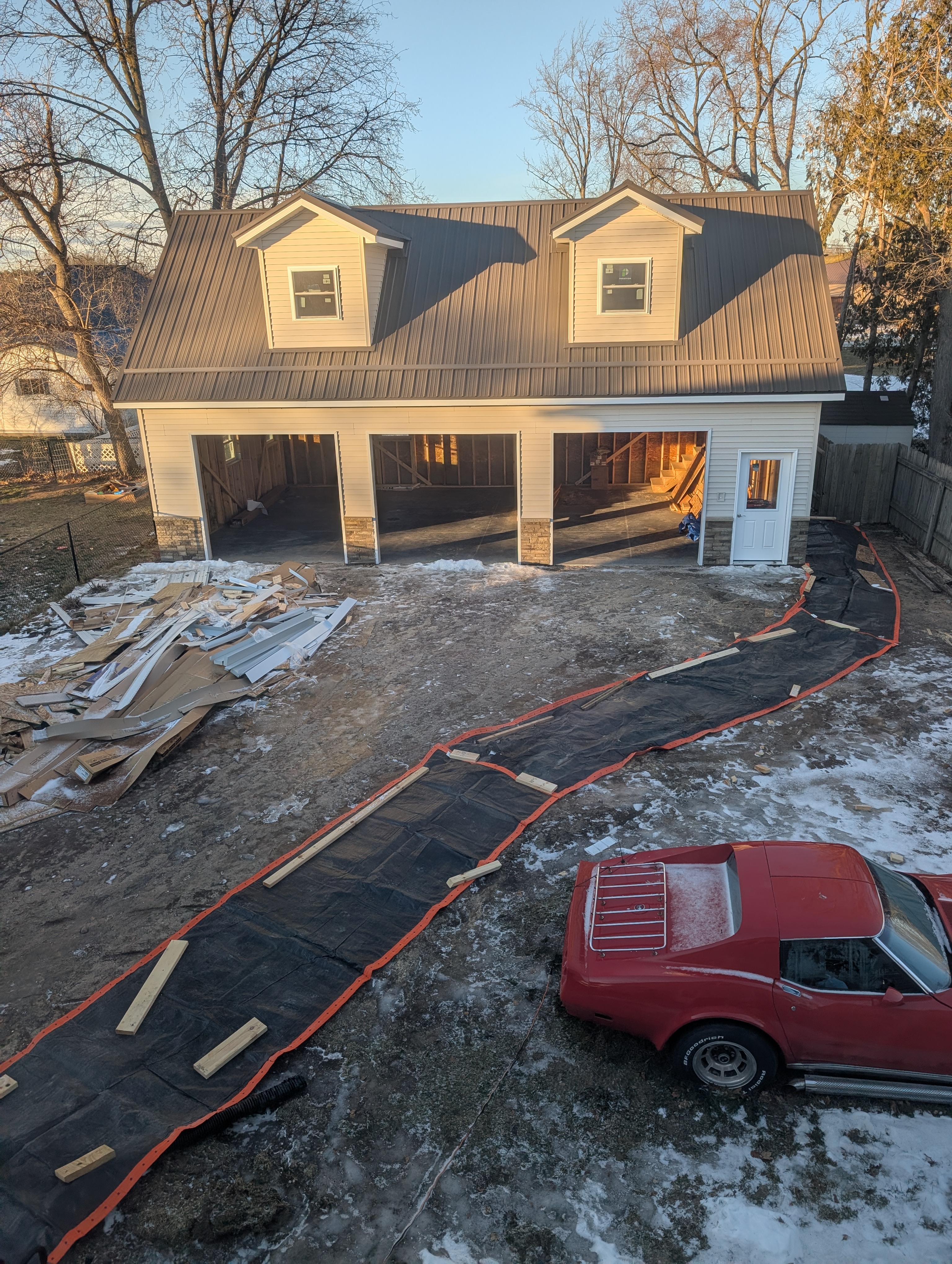 Concrete blankets laid out to thaw frozen ground for electrical trench