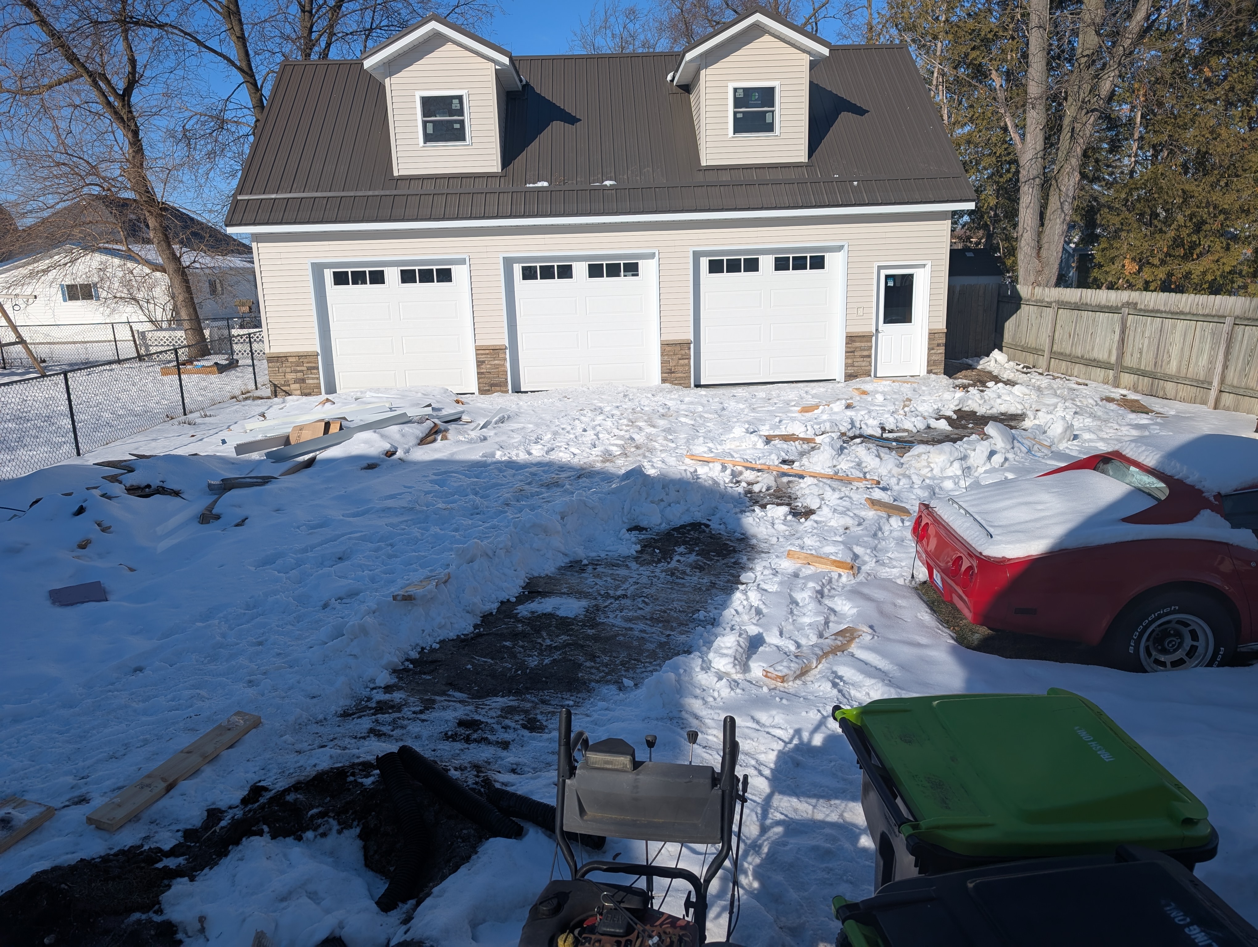 Backyard view showing exposed ground after cement blanket removal