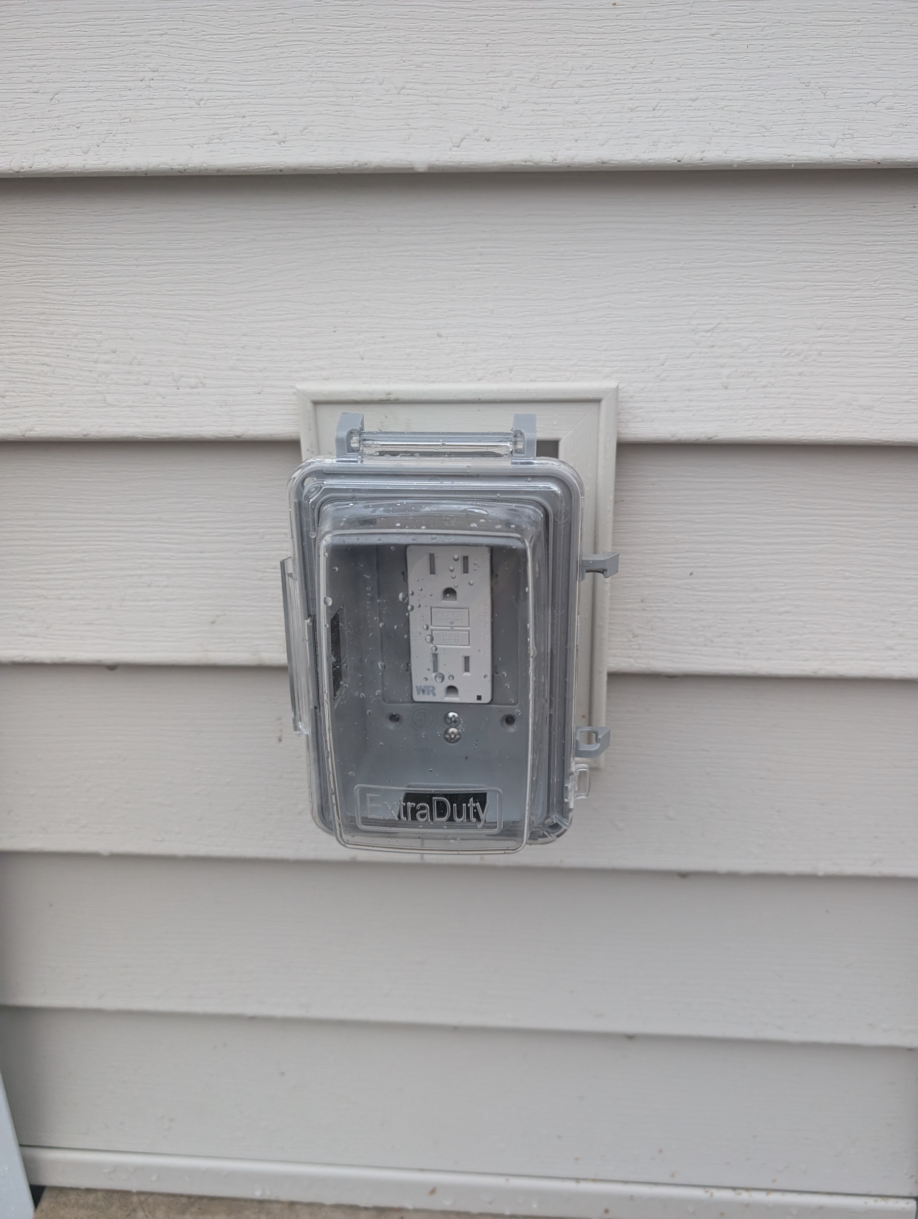 Exterior weatherproof GFCI outlet on garage siding