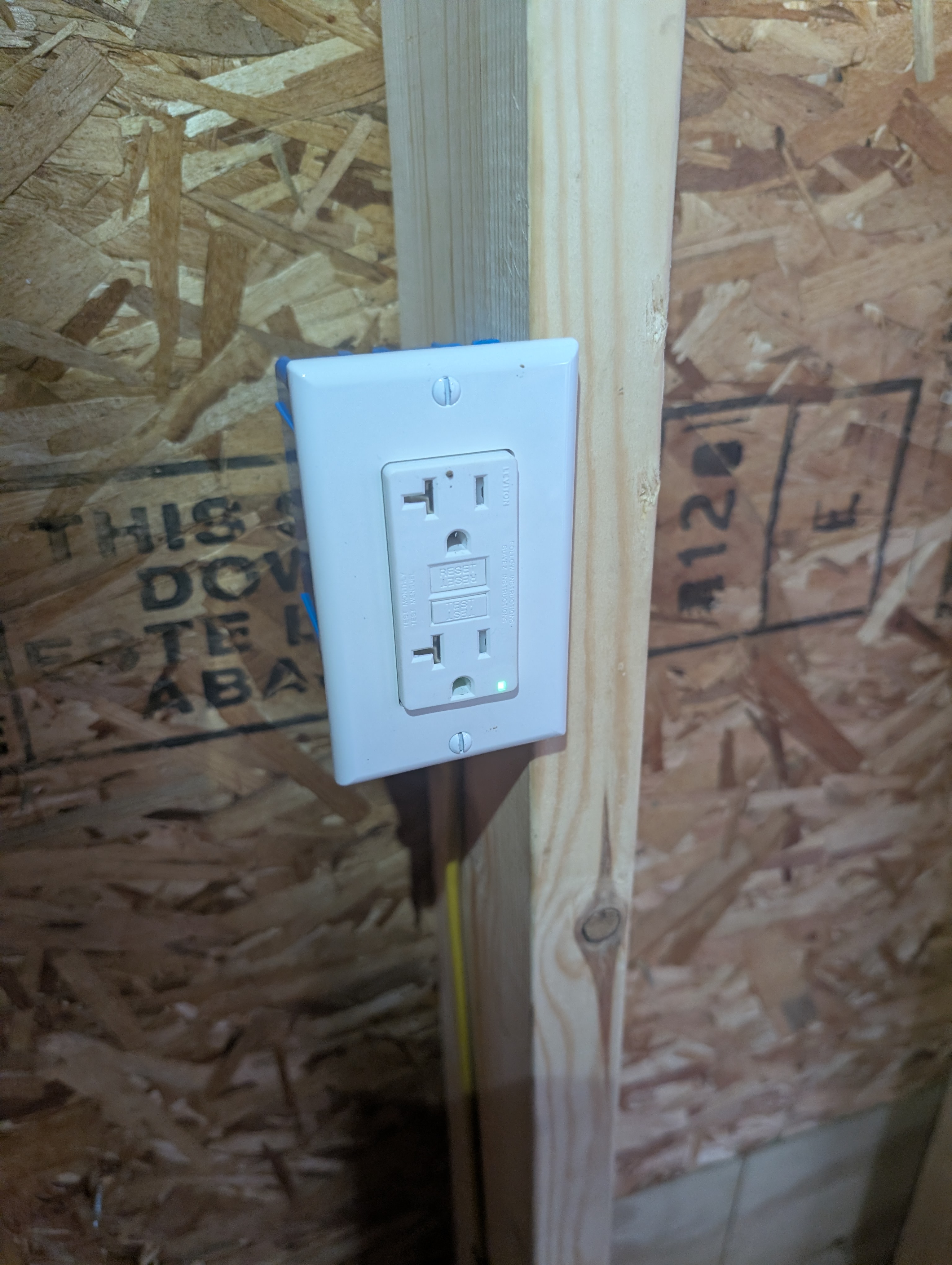 Interior GFCI outlet installed on stud near panel