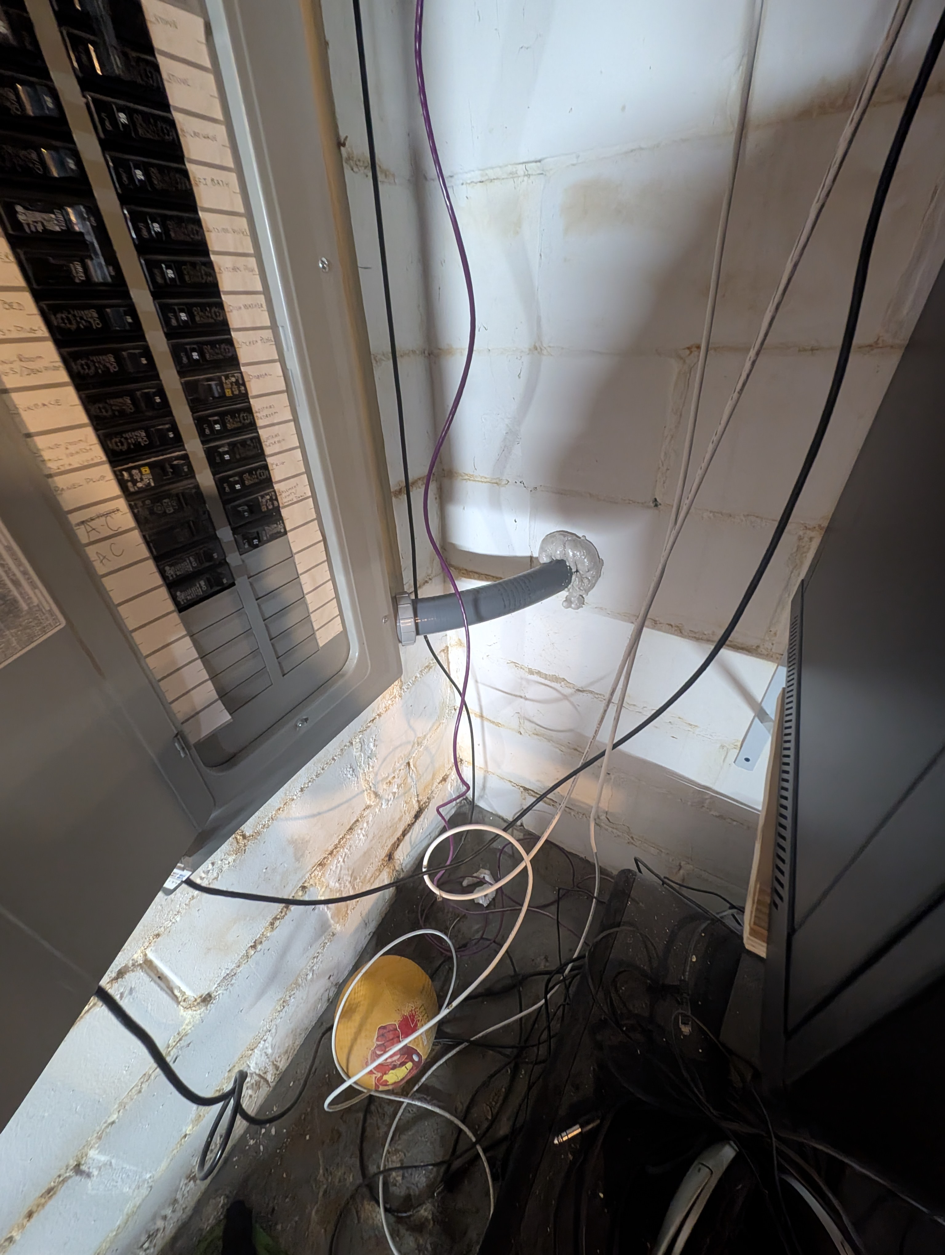 House main electrical panel area showing feeder connection point with conduit and wiring